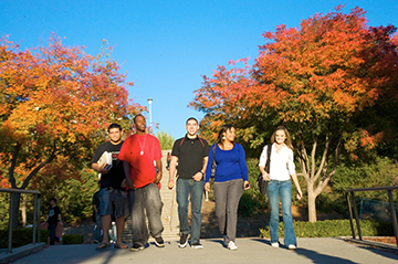 Image of students walking through the fall foliage.