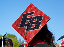 Image of graduation cap with "EB" artwork.
